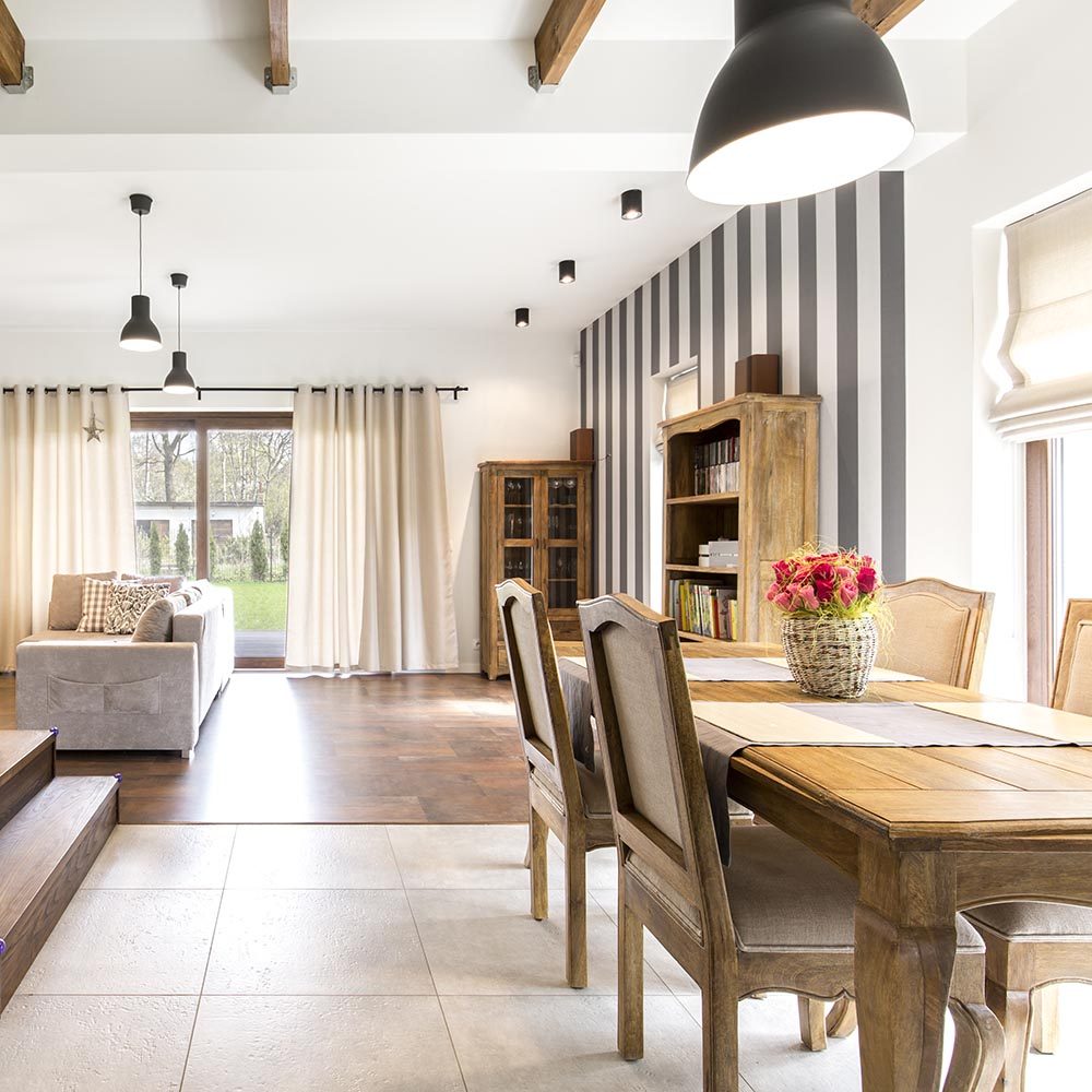 Elegant house interior with spacious dining hall and wooden vintage furnitures